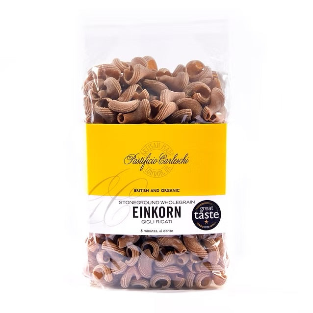 Packaging of Pastificio Carleschi Organic Einkorn Gigli Rigati Pasta, showing the pasta inside a transparent plastic bag with a yellow label, stating it is stoneground wholegrain einkorn and gluten-free.