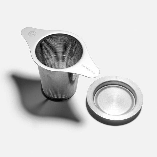 Stainless steel tea infuser with lid on a white background