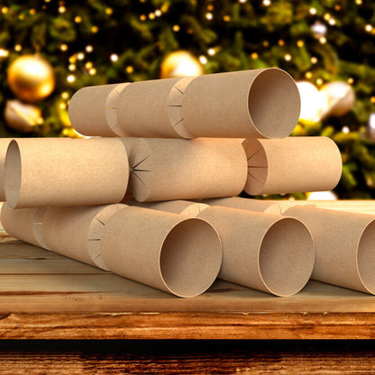 Stack of brown kraft boards with pre-cut holes for inserting into Christmas crackers, placed on a wooden surface with a festive background.